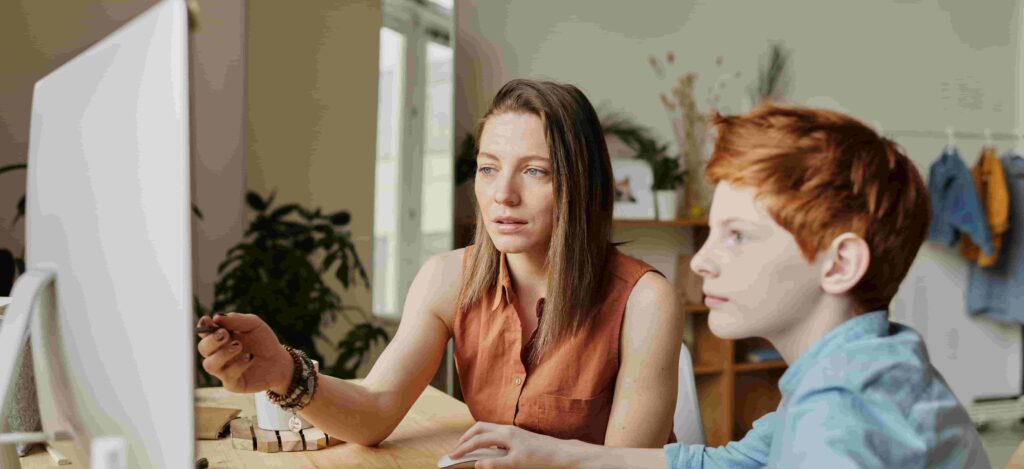 woman teaching a boy